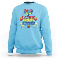 Sky blue sweatshirt with colorful puzzle heart autism slogan graphic