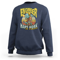 Navy crewneck sweatshirt with front “Engineered Hard Work In Progress” graphic