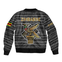 Black unisex bomber jacket, back tribal pattern with Zimbabwe bird graphic and rib hem.
