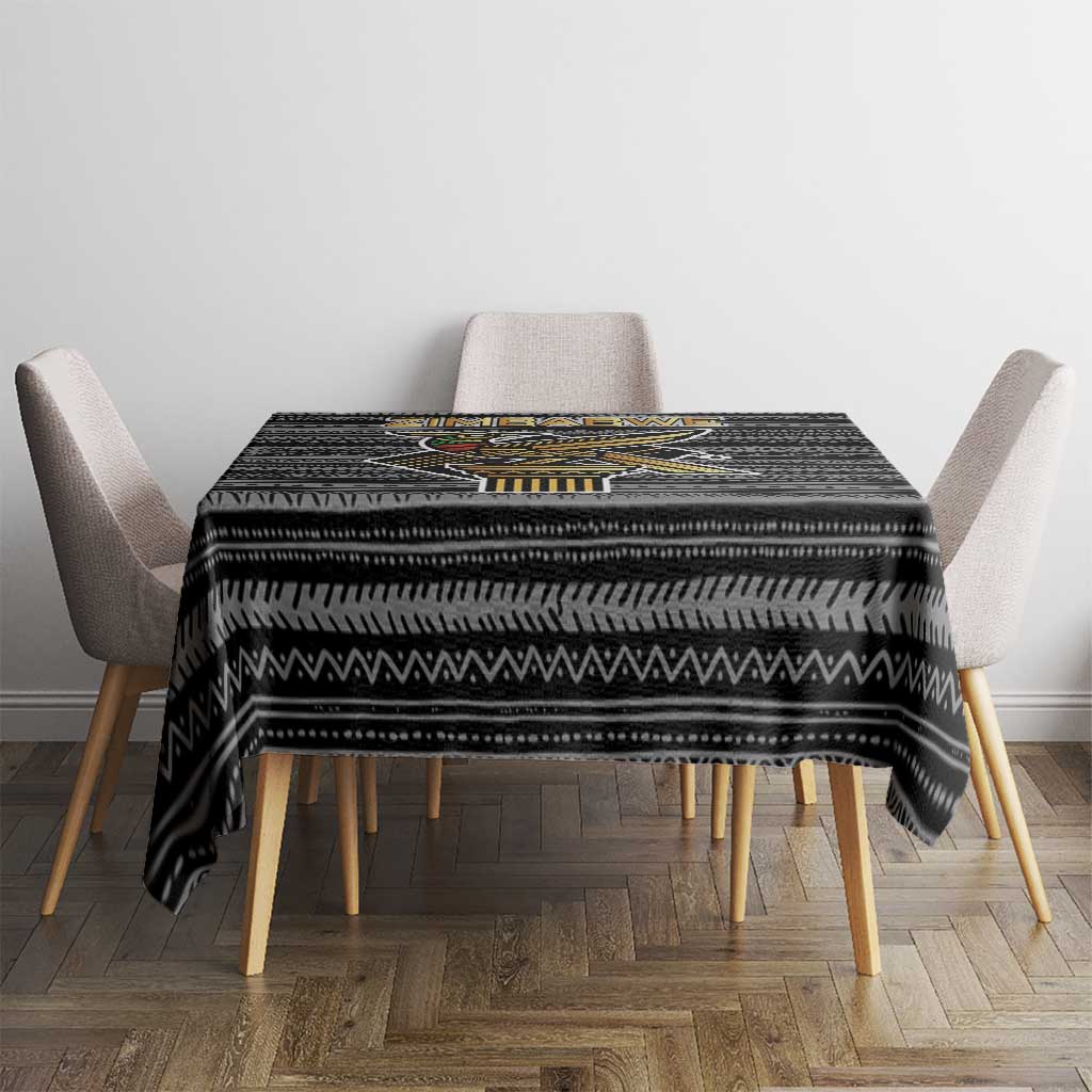 Black tribal pattern tablecloth on square table with matching chair arms