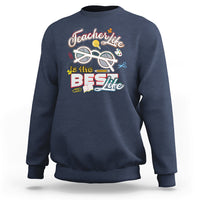 Navy teacher sweatshirt with “Teachers Life is the Best Life” graphic on chest.