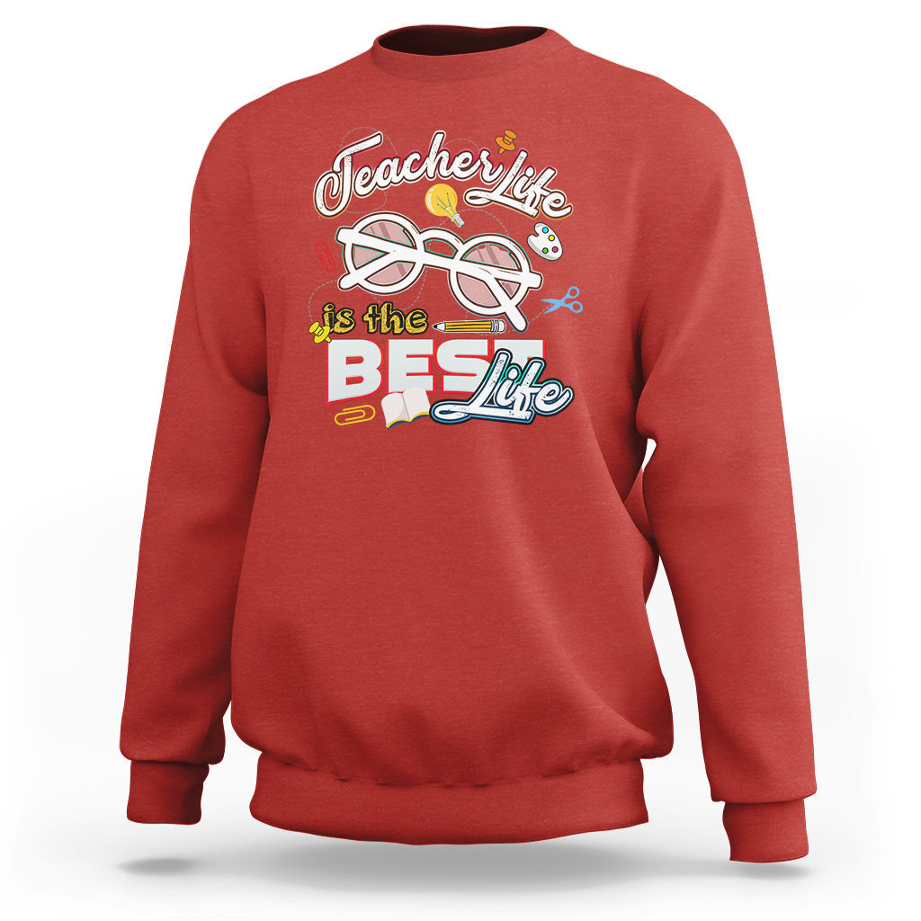 Red teacher sweatshirt with “Teachers Life is the Best Life” graphic on chest.