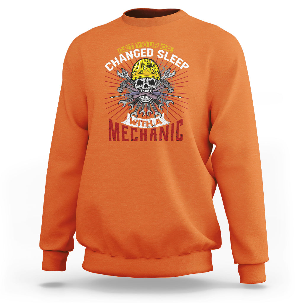 Orange sweatshirt with mechanic skull graphic on chest, crew neck and long sleeves