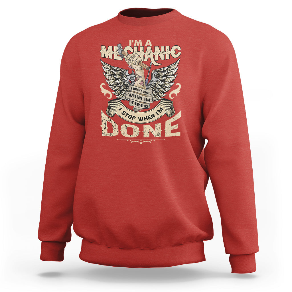 Red crewneck mechanic sweatshirt with winged “DONE” graphic on the front.