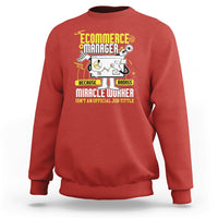 Red crewneck sweatshirt with front “Ecommerce Manager” graphic and text.
