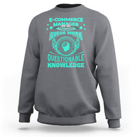 Charcoal crewneck sweatshirt with teal graphic and winged circular “Questionable Knowledge” print