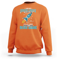 Orange crewneck sweatshirt with colorful astronaut graphic and tech-style text print on chest