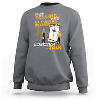 Charcoal gray crewneck sweatshirt with elevator mechanic graphic and bold text on front