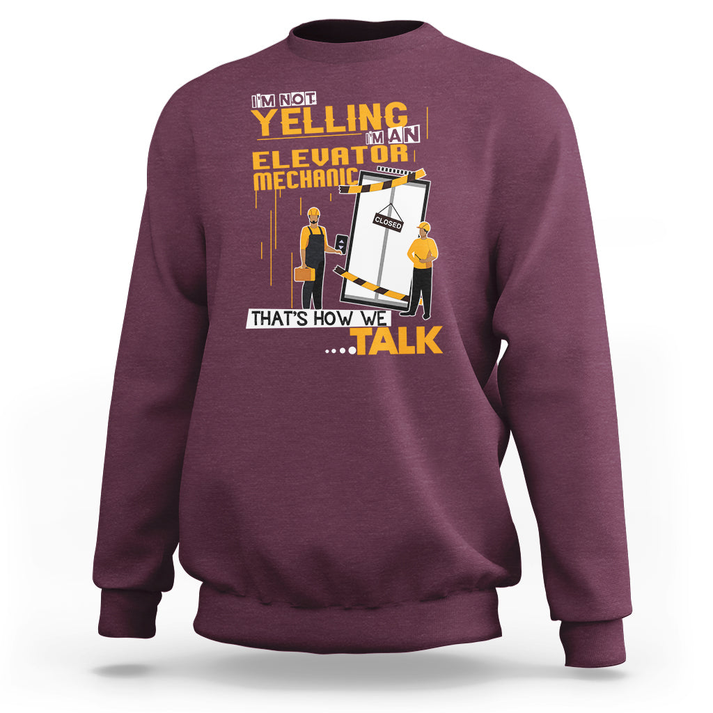 Maroon crewneck sweatshirt with elevator mechanic graphic and bold text on front