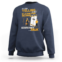 Navy crewneck sweatshirt with elevator mechanic graphic and bold text on front