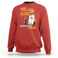 Red crewneck sweatshirt with elevator mechanic graphic and bold text on front