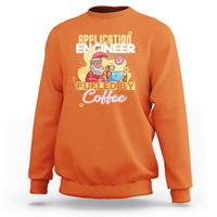 Coffee-themed engineer sweatshirt in orange, with front “Fueled by Coffee” graphic