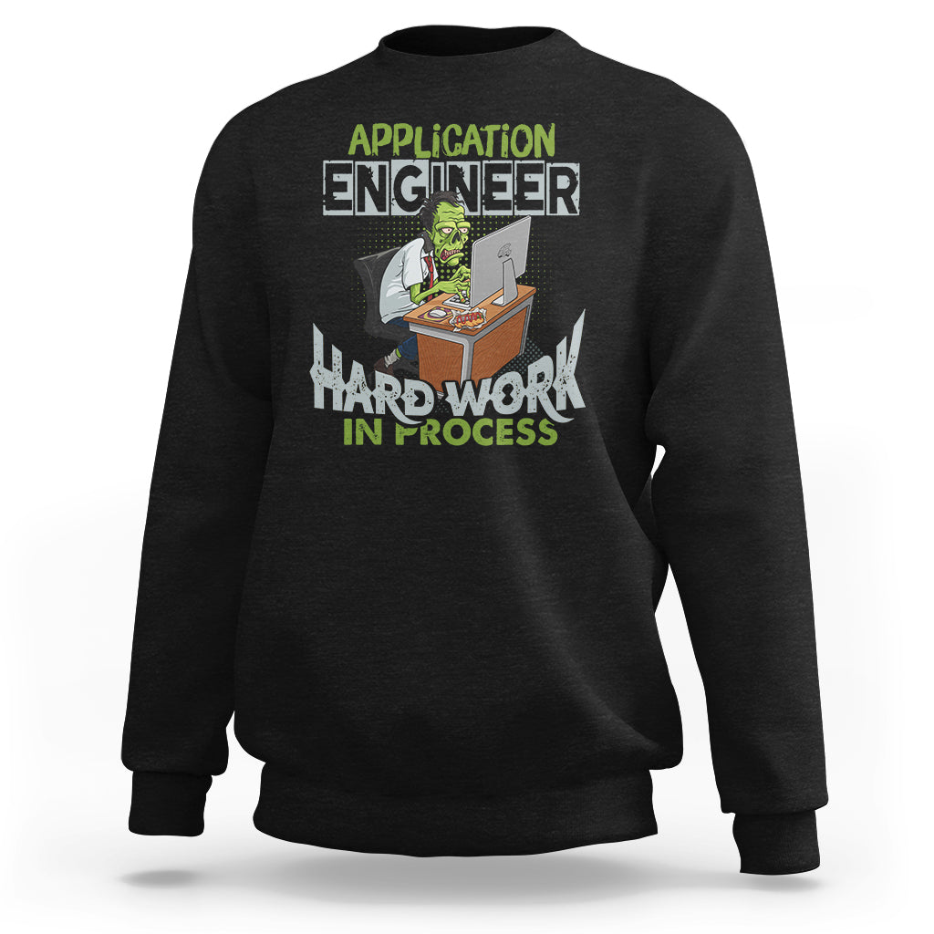 Black crewneck sweatshirt with colorful “Application Engineer” and “Hard Work in Process” graphic.