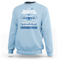 Light blue sweatshirt with “Aviation Inspector” chest graphic in white and blue