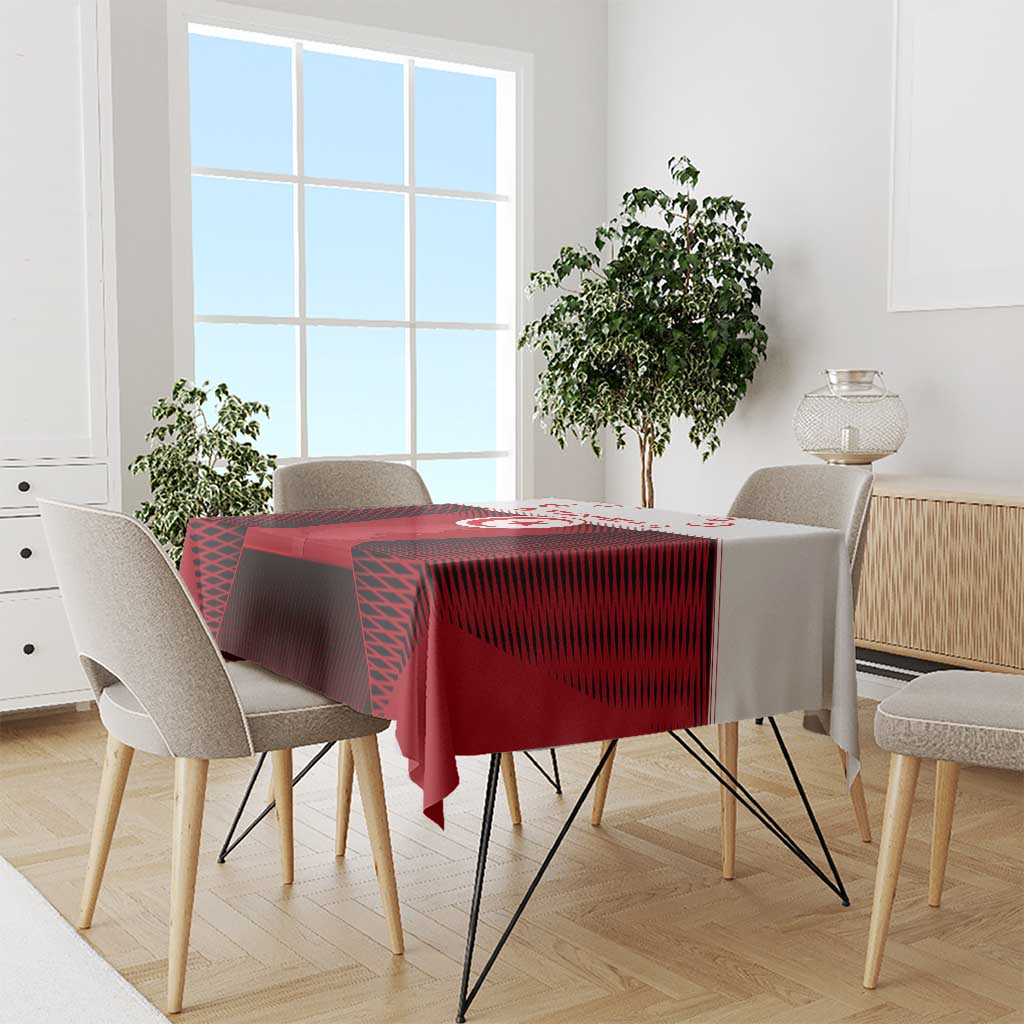 Red tablecloth with Tunisia emblem and crescent star pattern on a dining table
