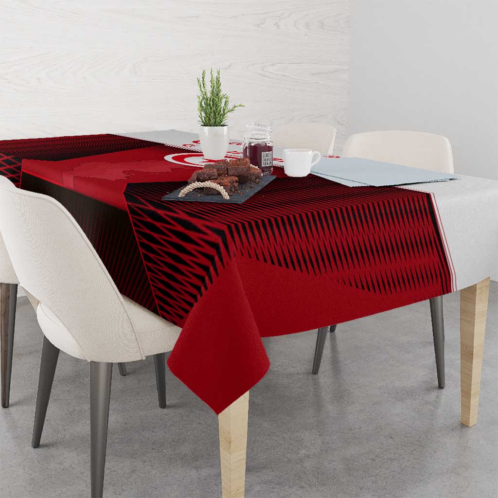 Red tablecloth with Tunisia map and crest, draped over dining table corner
