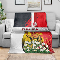 Tunisia blanket with camel, jasmine flowers, and Tunisia flag design on a sofa, multicolor