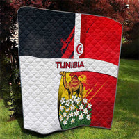 Quilted Tunisia quilt with flag, camel and white flowers, folded on grass
