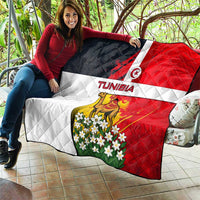 Tunisia flag quilt draped over couch arm, camel and white jasmine-like flowers