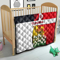 Tunisia quilt over a baby bed with flag design, camel and white floral artwork