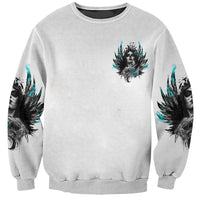 Unisex gray sweatshirt with small sugar skull and teal feather-wing graphic