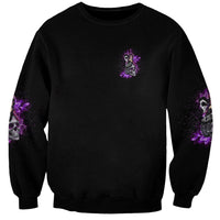 Unisex black crewneck sweatshirt with small purple graphic and purple sleeve accents
