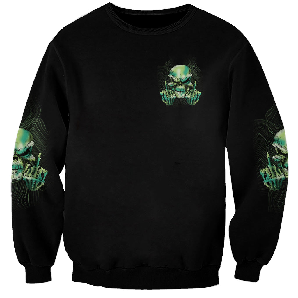 Black sweatshirt with small green skull logo and partial sleeve skull prints