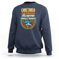 Navy crewneck sweatshirt with colorful “Caretaker” miracle worker graphic