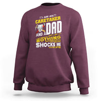 Maroon sweatshirt with colorful 'Caretaker Dad' novelty slogan graphic