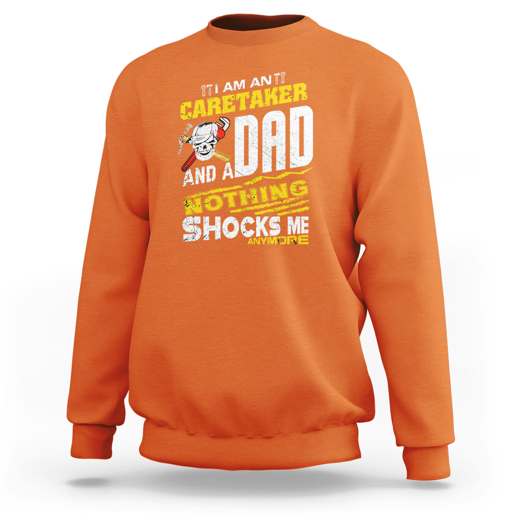Orange sweatshirt with colorful 'Caretaker Dad' novelty slogan graphic