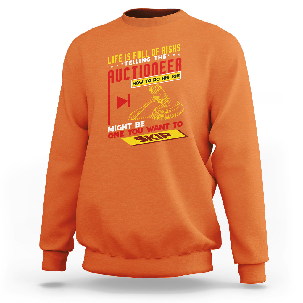 Orange crewneck sweatshirt with colorful 'Auctioneer' graphic on the front