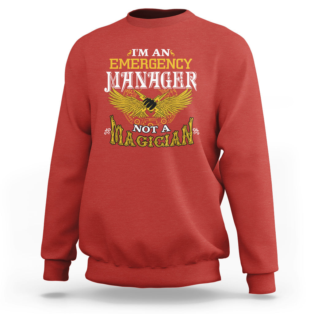 Red sweatshirt with 'Emergency Manager' and 'Not a Magician' eagle graphic on front.