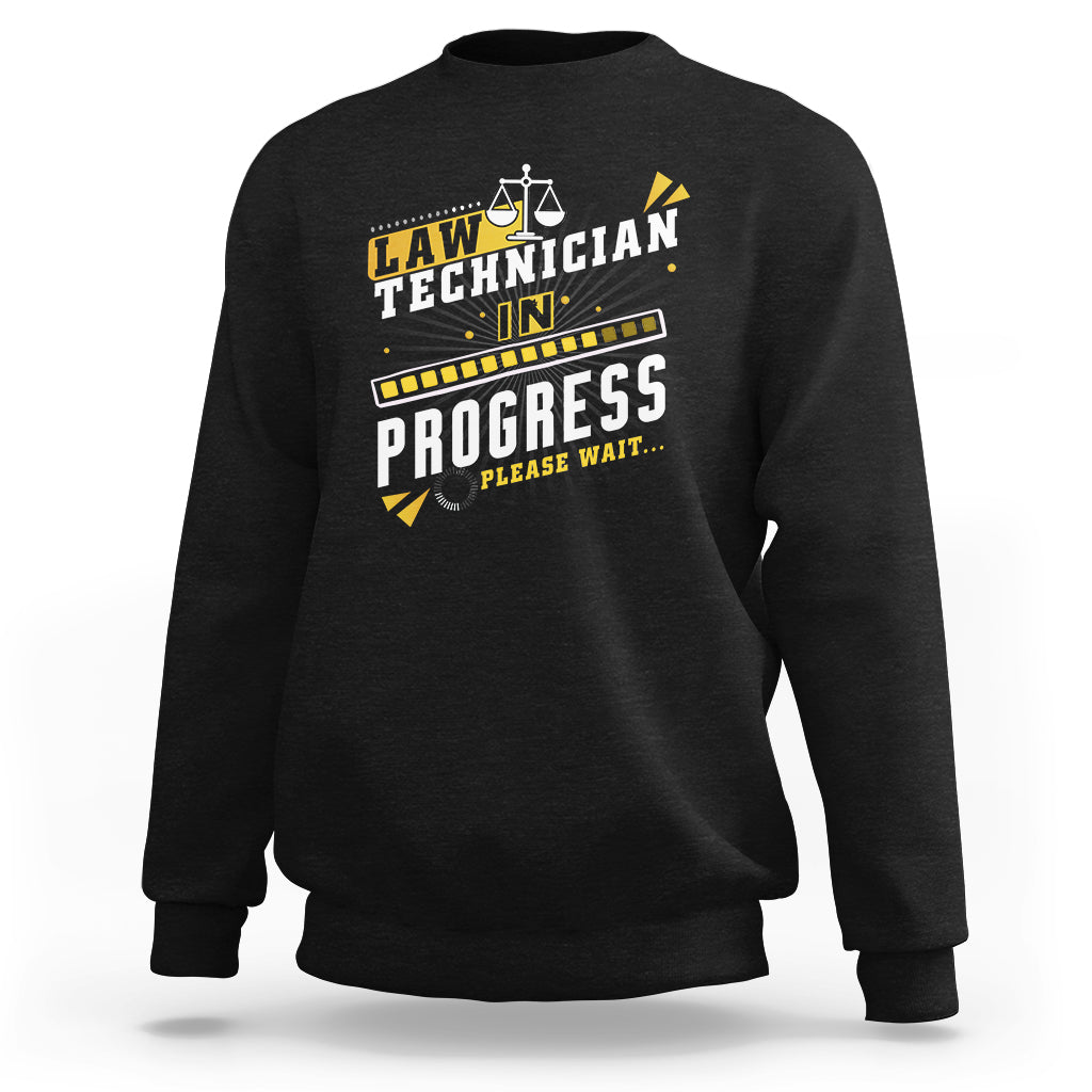 Charcoal crewneck sweatshirt with filmstrip "In Progress" graphic and scales icon