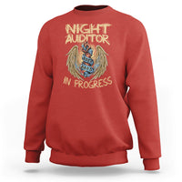 Red crewneck sweatshirt with Night Auditor in progress angel emblem