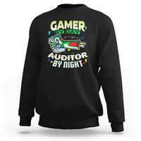 Black crewneck sweatshirt with “GAMER BY DAY” and “AUDITOR BY NIGHT” chest graphic.