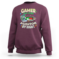 Maroon crewneck sweatshirt with “GAMER BY DAY” and “AUDITOR BY NIGHT” chest graphic.