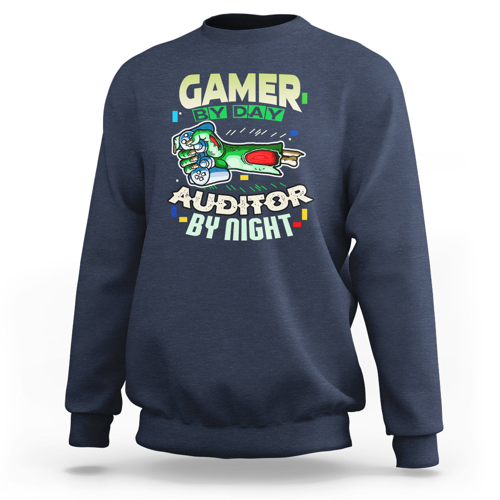 Navy crewneck sweatshirt with “GAMER BY DAY” and “AUDITOR BY NIGHT” chest graphic.