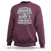 Maroon crewneck sweatshirt with large front “Shutter Driver” graphic print.