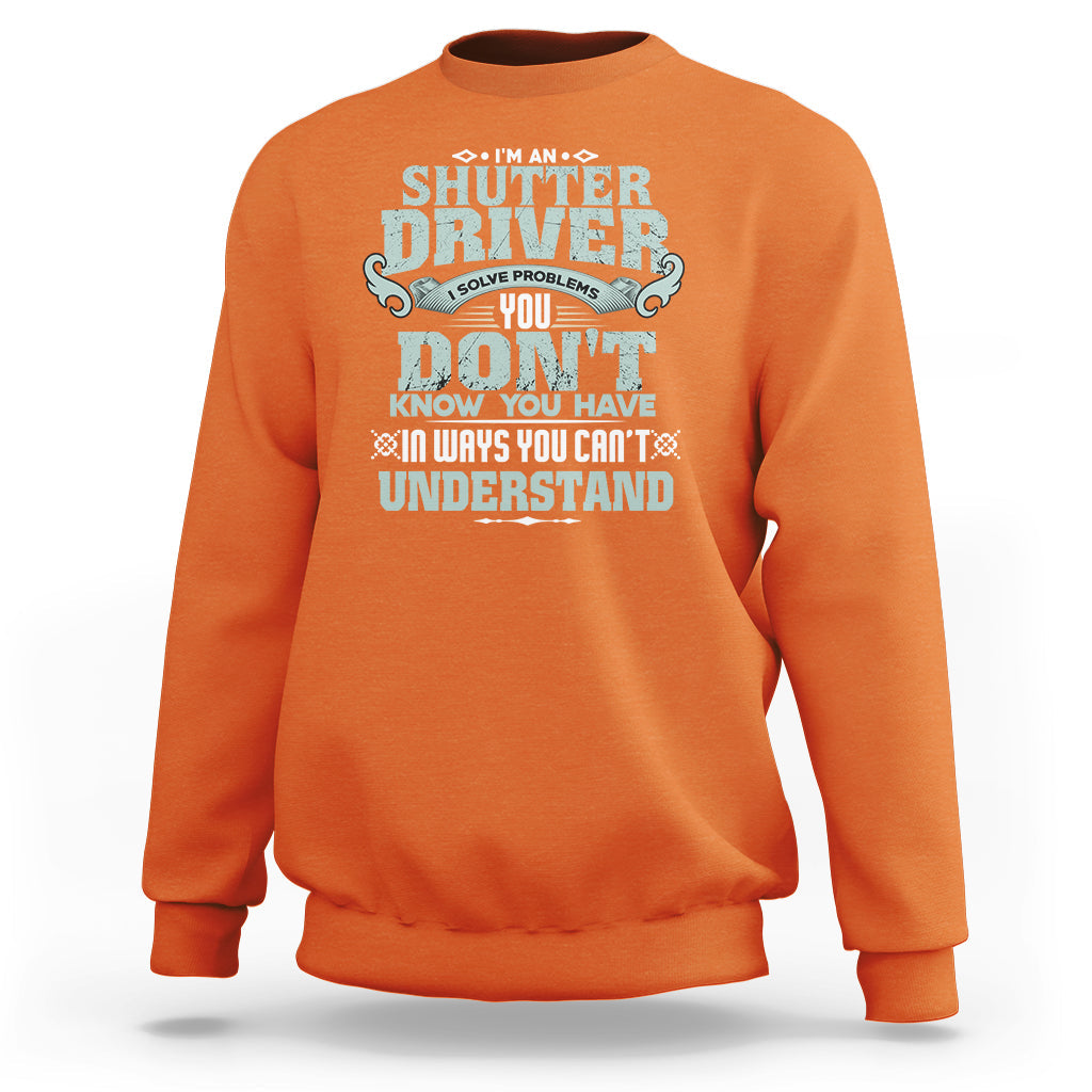 Orange crewneck sweatshirt with large front “Shutter Driver” graphic print.