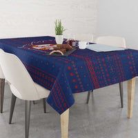 Blue tablecloth with red repeating national motif and coat-of-arms centerpiece
