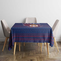 Blue tablecloth with red national pattern and crest graphic on dining table