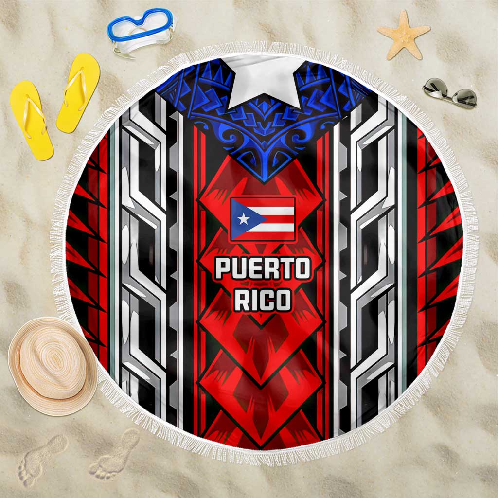 Round beach blanket with red, blue, black, and white Puerto Rico tribal emblem, fringed edge