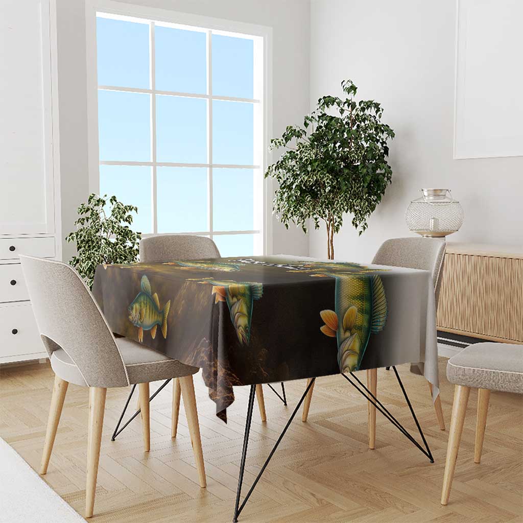 Walleye fish print tablecloth with dark gradient and yellow scales, covering a dining table.