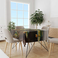Walleye fish print tablecloth with dark gradient and yellow scales, covering a dining table.