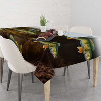 Dark walleye fish tablecloth with bright yellow fins and scales, draped over dining chairs.