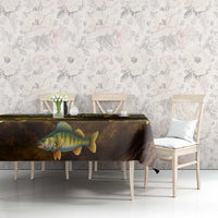 Walleye fish tablecloth with dark gradient and yellow-scale print, set on dining table.