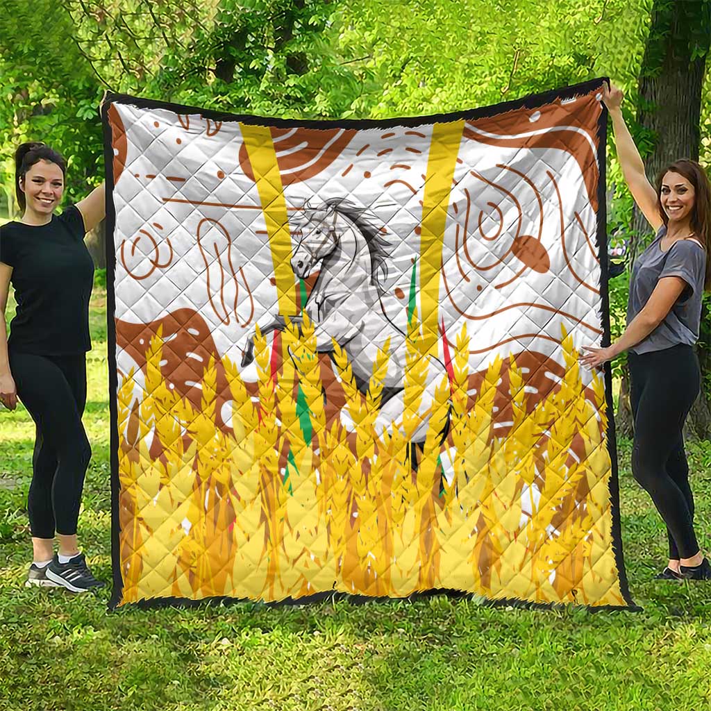 Multicolor quilt laid flat outdoors with gray horse, brown swirls, and bright yellow lower section