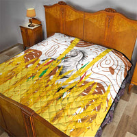 Multicolor quilt on bed with white field, brown accents, gray horse design, and yellow textured panel