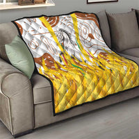 Multicolor quilt on sofa with gray horse center, brown swirl patterns, and bright yellow bottom