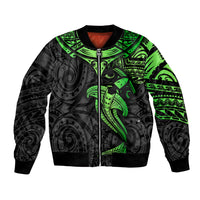 Black bomber jacket with green tribal shark pattern, full-zip front, ribbed cuffs